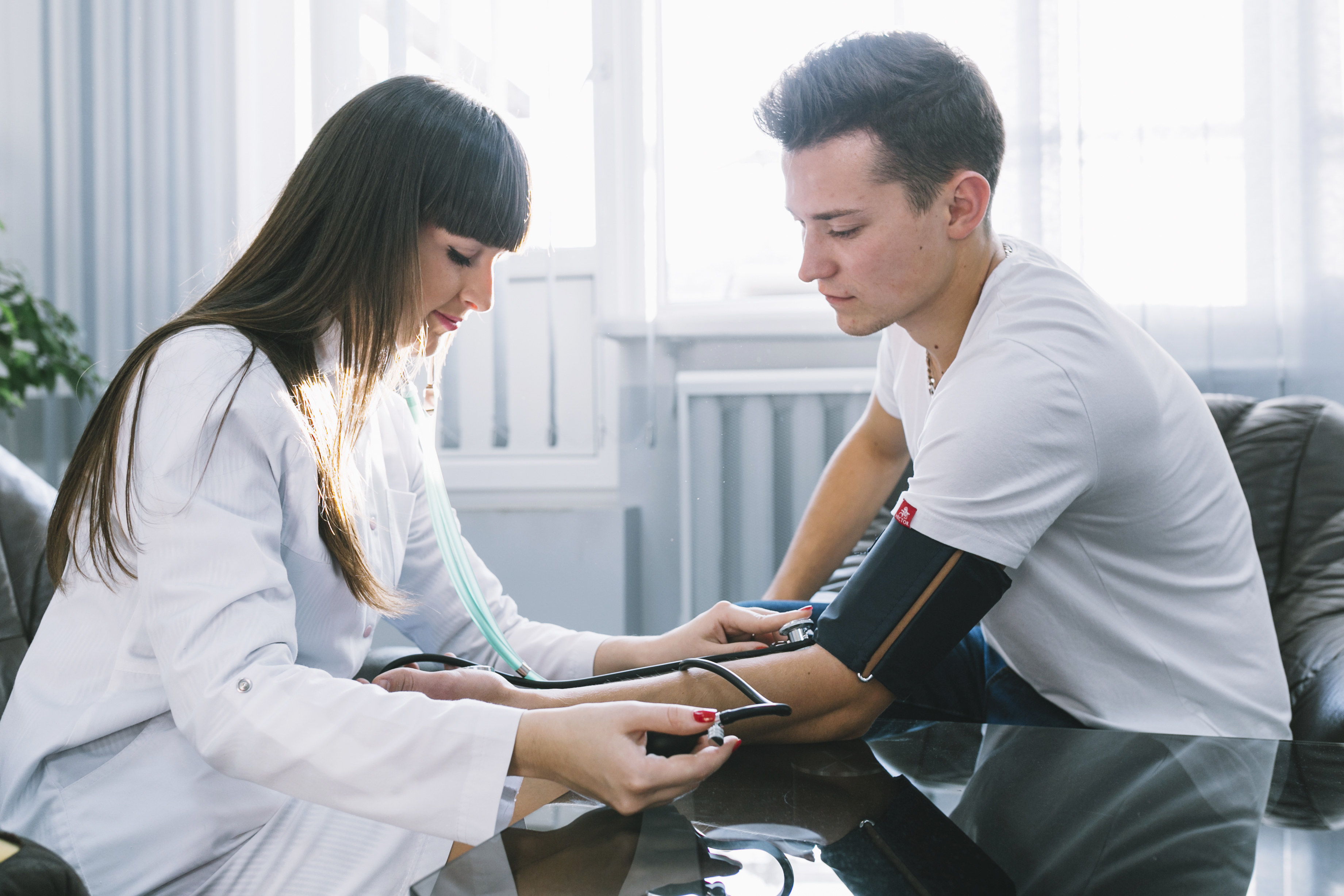 woman-measuring-pressure-pulse-patient
