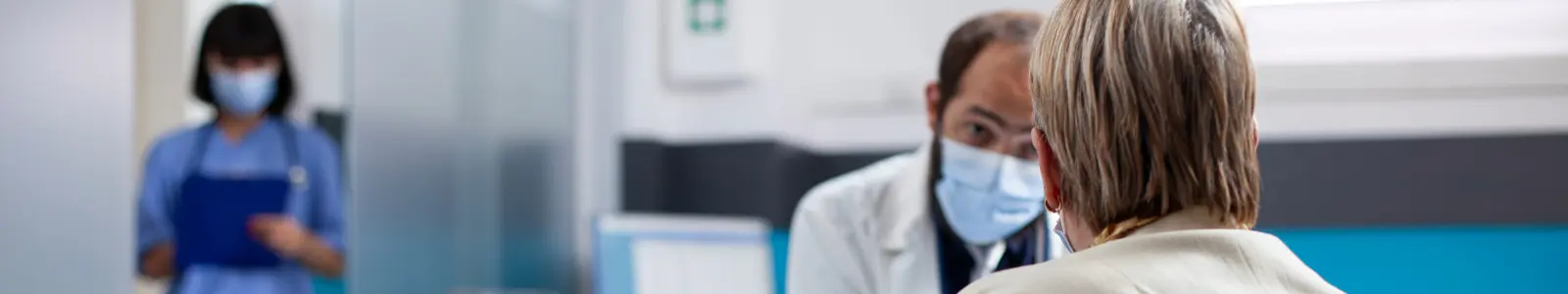 Médico atendiendo a una paciente adulta, representación de la protección financiera ante enfermedades graves.
